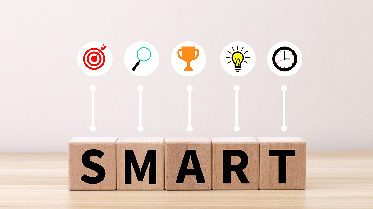 THe letters S M A R T with an emoji above each letter to help describe SMART goals.