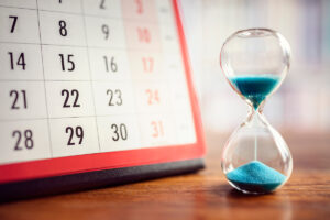 A calendar with a sand timer