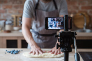 Video producer is filming a baker to highlight his business.