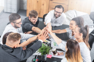 A team meeting in the office. They are celebrating.