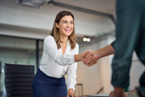 A woman shaking someone's hand.