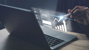 A laptop with graphics looking at the success of advertising campaigns.