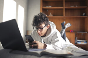A prospective student watching videos on his phone.