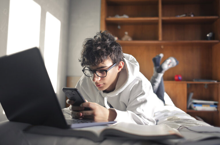 A prospective student watching videos on his phone.