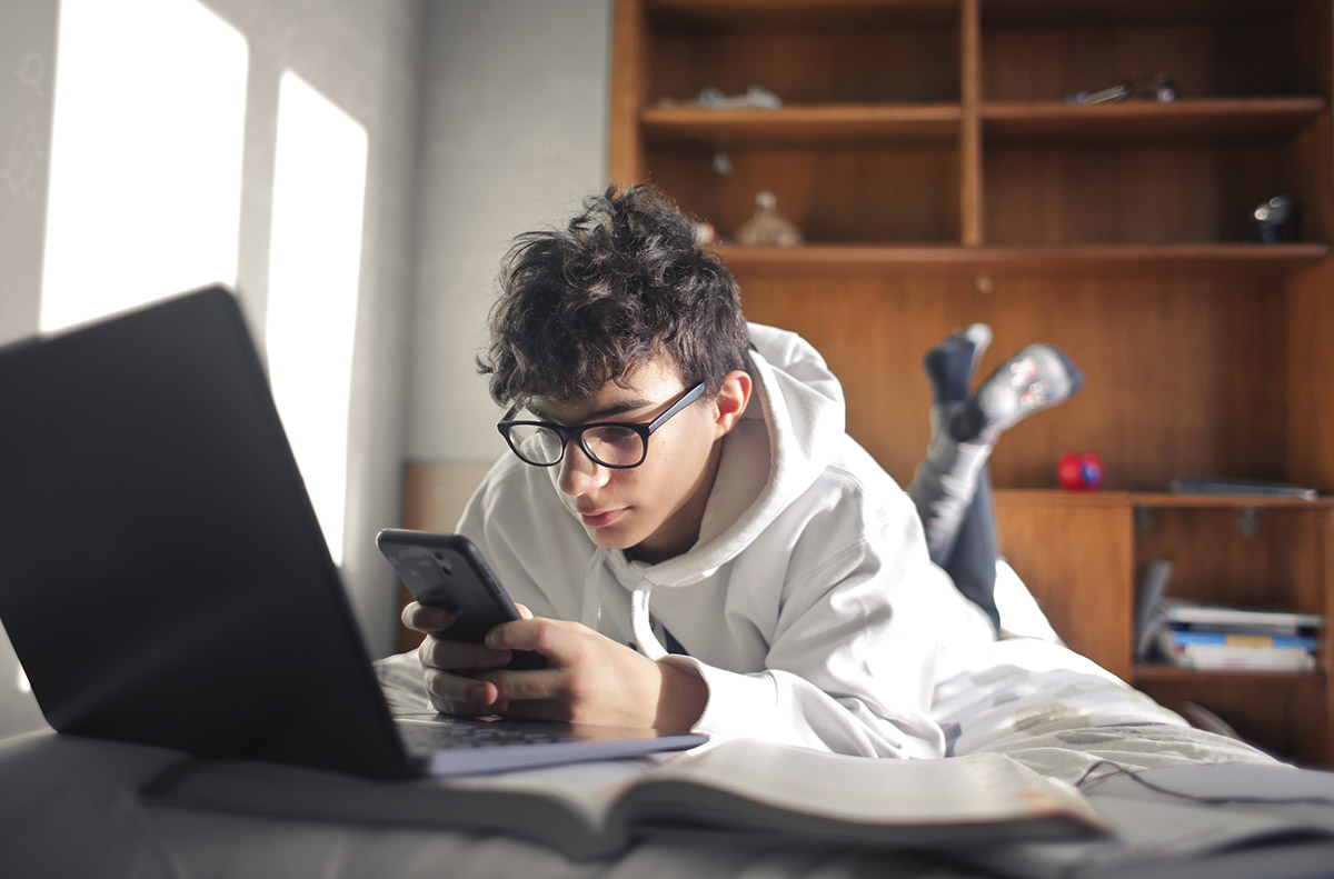 A prospective student watching videos on his phone.